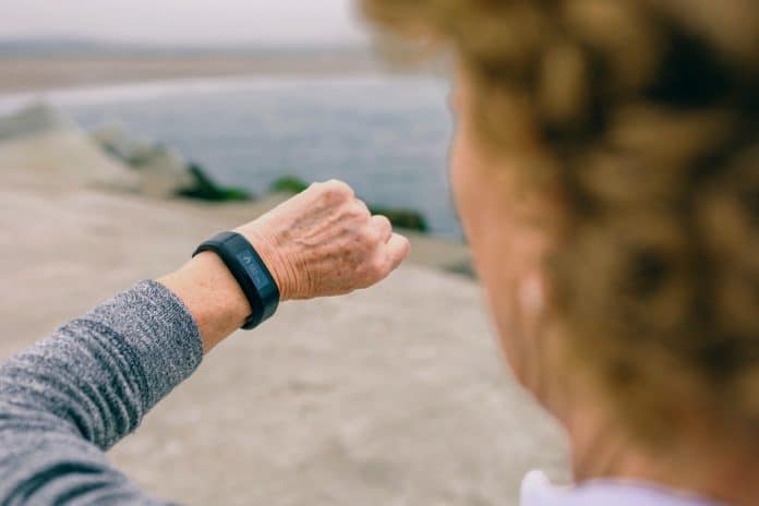 Unrecognizable senior woman looking smart watch